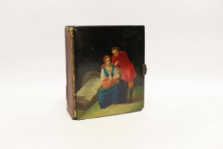 * * A Russian lacquer boarded photograph album, Lukutin, late 19th century, decorated with a