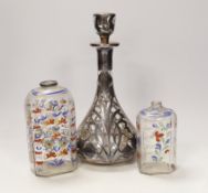 An Art Nouveau white metal jacketed decanter, together with a pair of German enamelled glass flasks,