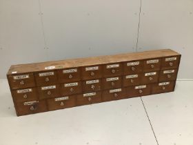 A nest of pine pharmacist's drawers, width 183cm, height 49cm***CONDITION REPORT***PLEASE NOTE:-
