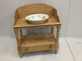 An Edwardian beech washstand with base drawer and associated ceramic basin, width 84cm***CONDITION
