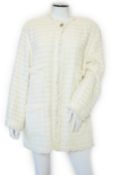 A Chanel early 1990's cream boutique jacket, with fringing to all edges, single CC silver-tone