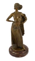 E. Leger, a bronze figure of an Eastern dancer standing with her hands on her hips, signed in the