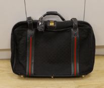 A black fabric and leather trimmed Gucci suitcase Condition worn***CONDITION REPORT***70 x