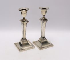 A pair of Edwardian silver candlesticks, with tapering square stems, Stewart Dawson & Co Ltd,