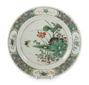 A Chinese famille verte ‘lotus pond’ plate, Kangxi period, painted with a butterfly hovering by a