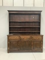 A late 18th century oak dresser base with associated rack, width 183cm, height 210cm***CONDITION