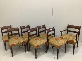 A set of seven Regency mahogany dining chairs with tablet cresting rails, upholstered seats on