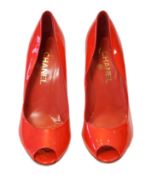 A pair of Chanel lady's metallic coral peep toe patent leather heels, with gold tone CC detail to