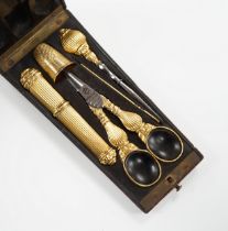 A 19th century French yellow metal (18ct poincon mark) necessaire, comprising a thimble, needle