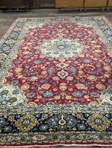 An Isphanan crimson ground carpet with central medallion and field of foliate motifs, multi-