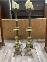 A pair of late 19th century brass altar sticks, height 70cm and a smaller pair of pricket