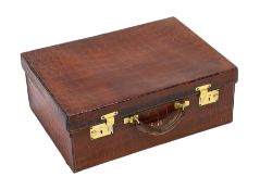A 1920's crocodile skin suitcase, with gilt initials EH and locks stamped English Lever, width 50cm,
