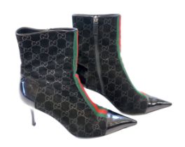A pair of Gucci monogram pattern and ribbon black lady's suede ankle boots, with toe and heel in