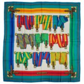 A Hermès Les Sangles silk scarf, with belt and buckle pattern in hues of white, red, blue, green,