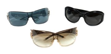 Three pairs of lady's Giorgio Armani sunglasses with cases and dust bags.***CONDITION REPORT***In