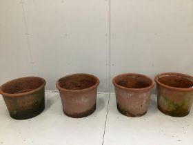 A pair of terracotta garden pots, diameter 50cm and another similar near pair of pots, diameter