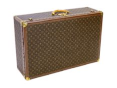 A Louis Vuitton monogrammed canvas and tan leather suitcase, with internal tray and Paris label