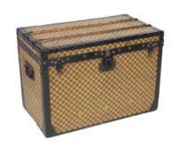 A Louis Vuitton Damier trunk, with black painted metal mounts and brass studded wooden slats over
