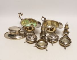 A small selection of silver items to include two sauceboats, a pair of cauldron salts, a further