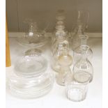 A collection of cut glass decanters and other glassware including five decanters with stoppers,
