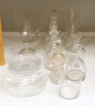 A collection of cut glass decanters and other glassware including five decanters with stoppers,