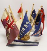 Collection of mid 20th century merchant shipping pennants on a stand and a boxed George V silver