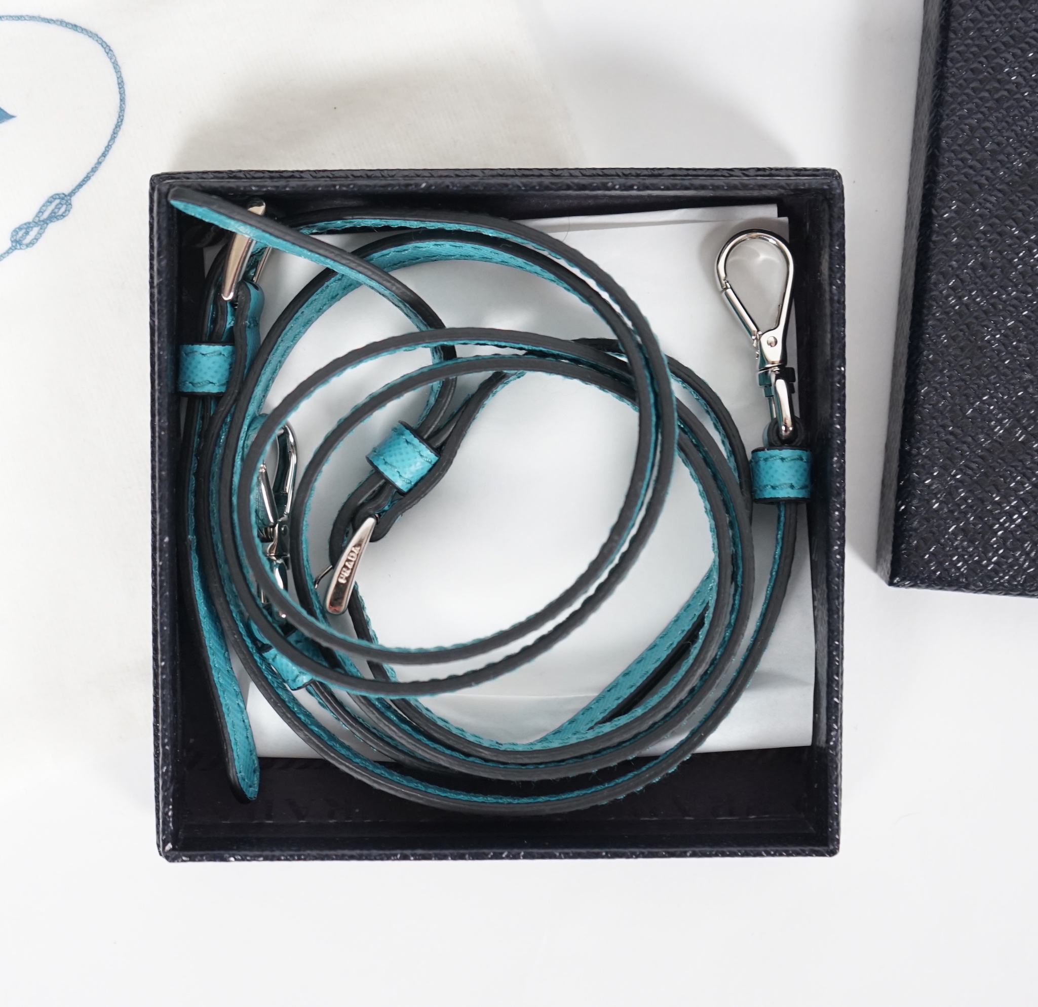 A Prada Saffiano Lux Mini Sound bag in Turchese, silver-tone hardware, with bag, box and - Image 8 of 8
