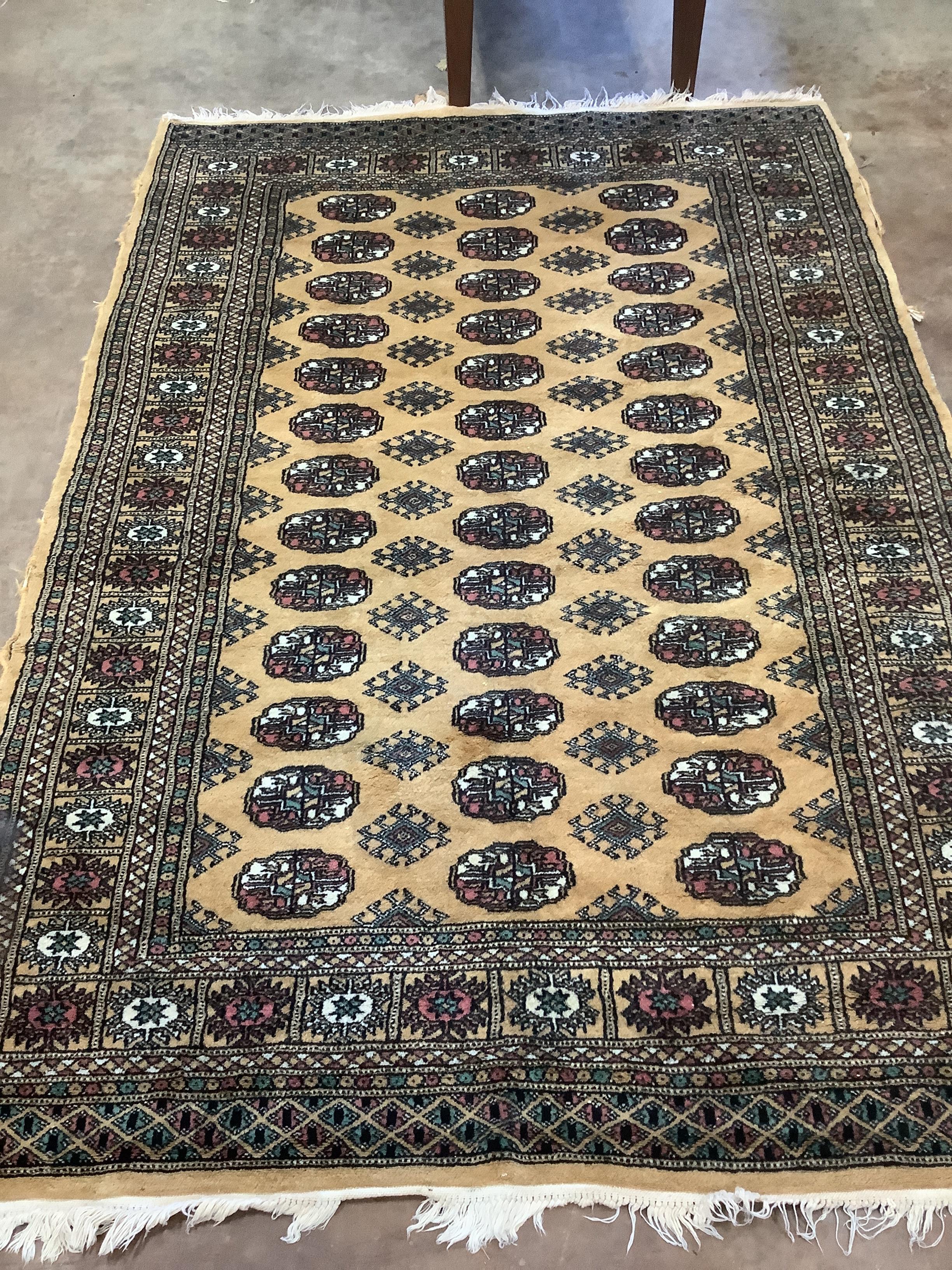 A Bokhara beige ground rug, 183 x 126cm***CONDITION REPORT***PLEASE NOTE:- Prospective buyers are