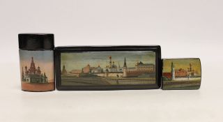 * * Two Russian lacquer ‘Kremlin’ stamp boxes and a similar vesta case, c.1900, largest 11cmPlease