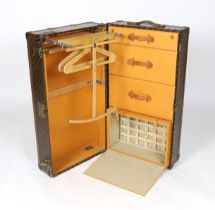 A vintage Louis Vuitton monogram canvas wardrobe trunk, with iron and brass mounts, and brass