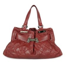 ** ** A Chanel burgundy leather buckled handle bag, with dust bag, Authentication no: 12244695 (with