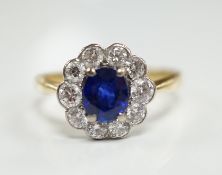A modern 18ct gold, sapphire and diamond set circular cluster ring, size P/Q, gross weight 3.8