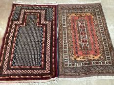 A North West Persian prayer rug, 140 x 85cm and a small red ground rug, 132 x 85cm***CONDITION
