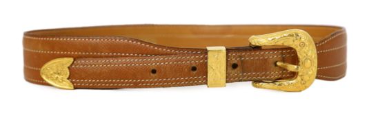 A Hermès lady's tan leather belt, with gold tone buckle and white stitching, size XS/Small***