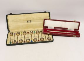 A cased set of twelve George V Liberty & Co silver coffee spoons, with gem set terminals including