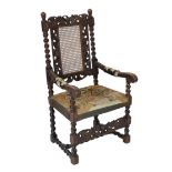 * * A Charles II carved walnut caned back elbow chair, with a contemporary needlework upholstered