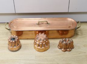 A copper fish kettle and three copper jelly moulds, largest 68.5cm***CONDITION REPORT***PLEASE