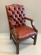 A reproduction mahogany Gainsborough type library chair with buttoned leather upholstery, width