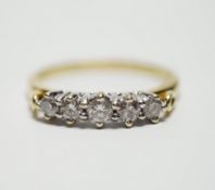 A modern 18ct gold and graduated five stone diamond set half hoop ring, size T, gross weight 4.4