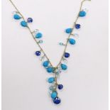 A modern 18ct gold and multi facet cut gem set fringe necklace, 56cm and matching bracelet, gross