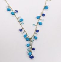 A modern 18ct gold and multi facet cut gem set fringe necklace, 56cm and matching bracelet, gross