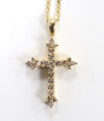A modern 9ct gold and diamond chip set cross pendant, overall 30mm, on a 9ct gold chain, 40cm, gross