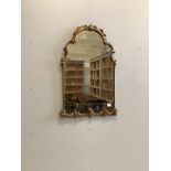 An 18th century giltwood and composition bevelled wall mirror of arched form, width 62cm, height