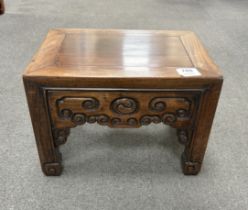 A Chinese low rectangular hardwood stand carved with scrolls, width 37cm, depth 28cm, height 26cm