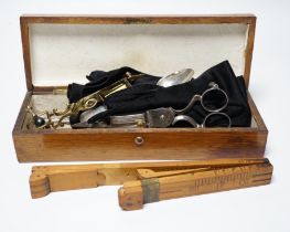 A glove box containing a boxwood foot-measure, two candle snuffers, a silver teaspoon etc