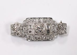 An Art Deco style white metal and millegrain set round and square cut diamond cluster pendant