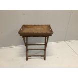 A Regency style caned faux bamboo butler’s tray on folding stand, width 61cm, depth 43cm, height