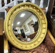 A Victorian giltwood and composition convex wall mirror, diameter 65cm