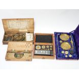 Four cased weighing sets, three of the sets with small scales included