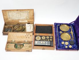 Four cased weighing sets, three of the sets with small scales included